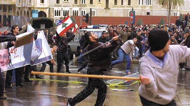 Thugs throw sticks and rocks at security officers in front of the Grand Sraille